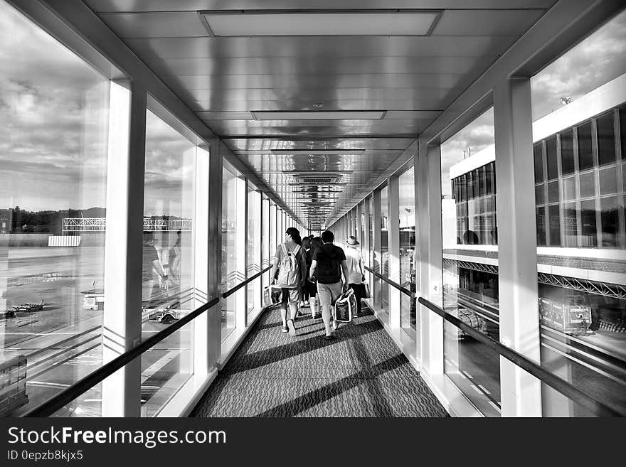 Person Carrying Bag Walking on Path Way