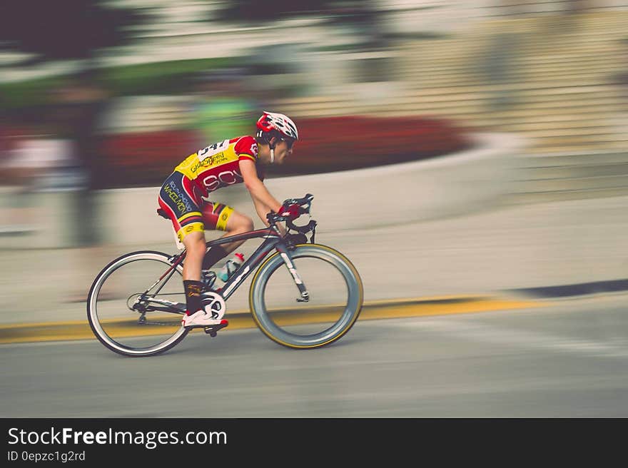 Blur of pan with man riding bike in race on roadway. Blur of pan with man riding bike in race on roadway.