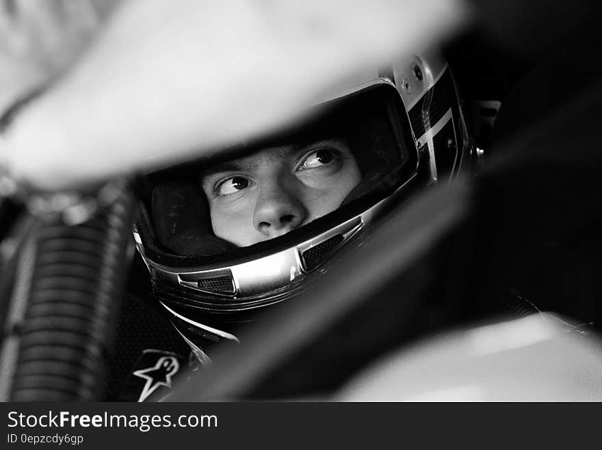 Gray Scale Image on Man Wearing Full Face Helmet