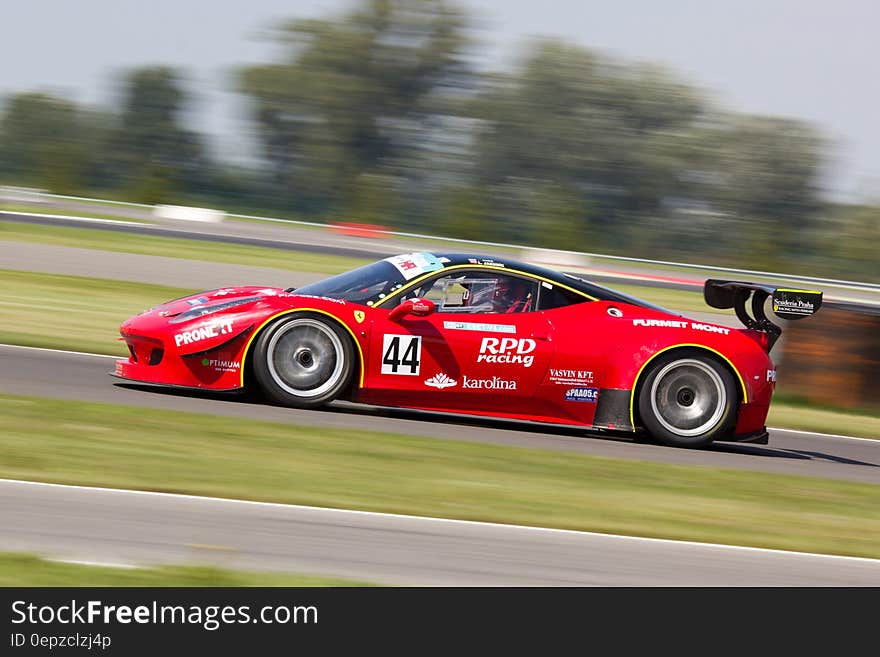 Red Racing Car on Race Track during Daytime