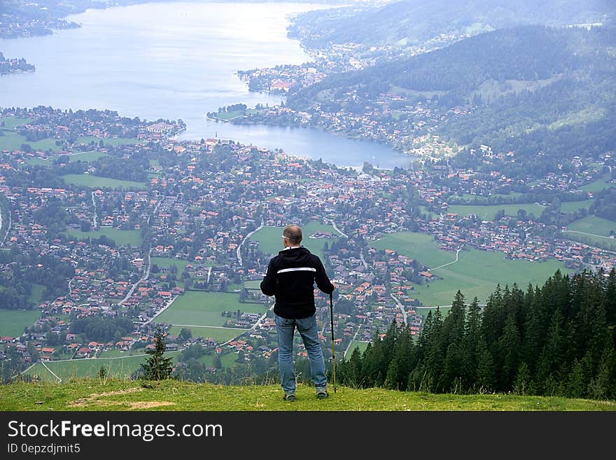 Hiker standing on hillside over village in Bavaria, Germany on Tegernsee Lake. Hiker standing on hillside over village in Bavaria, Germany on Tegernsee Lake.