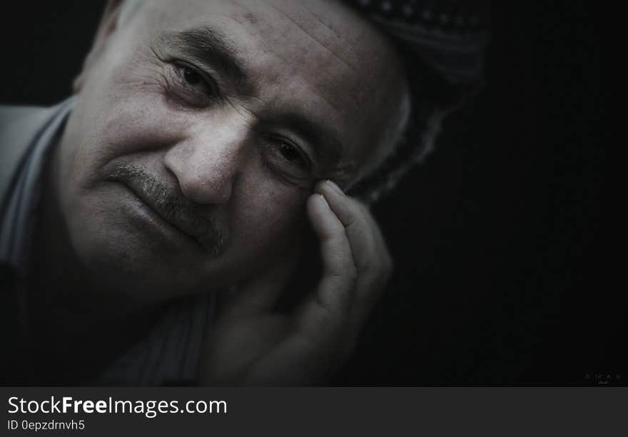 Close up portrait of senior man with mustache in studio. Close up portrait of senior man with mustache in studio.