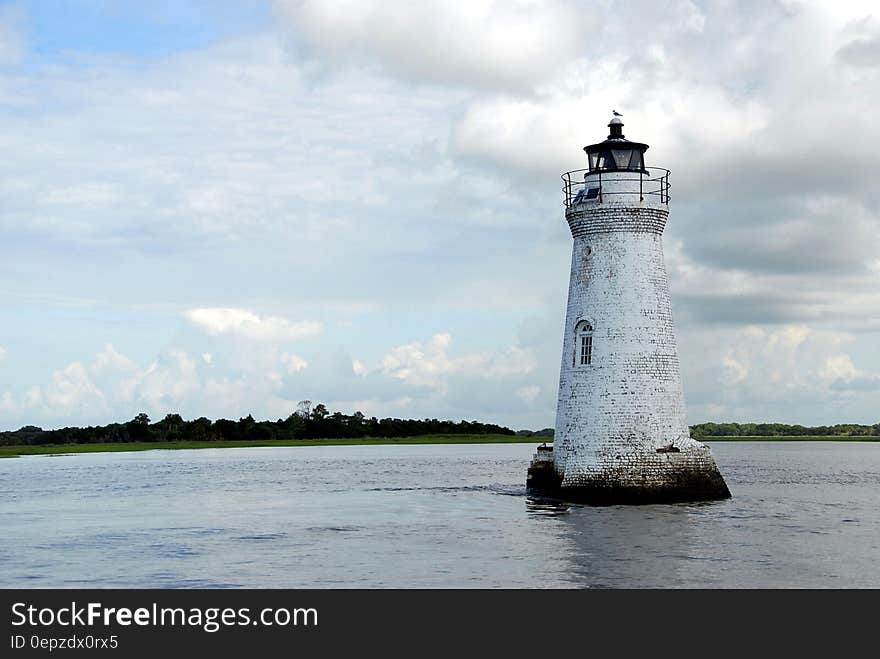 White Light House in the Middle of Sea