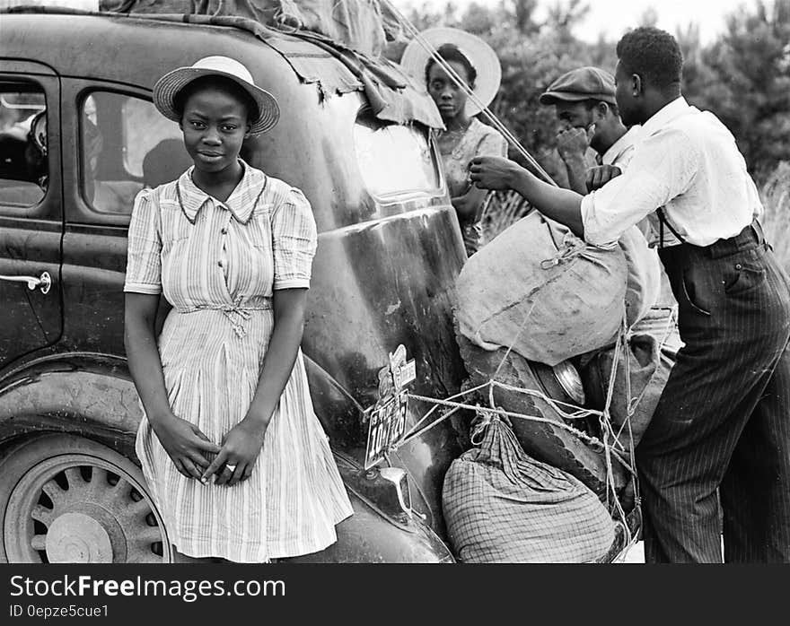 Woman in White Pinstripe Dress Near Black Vintage Car