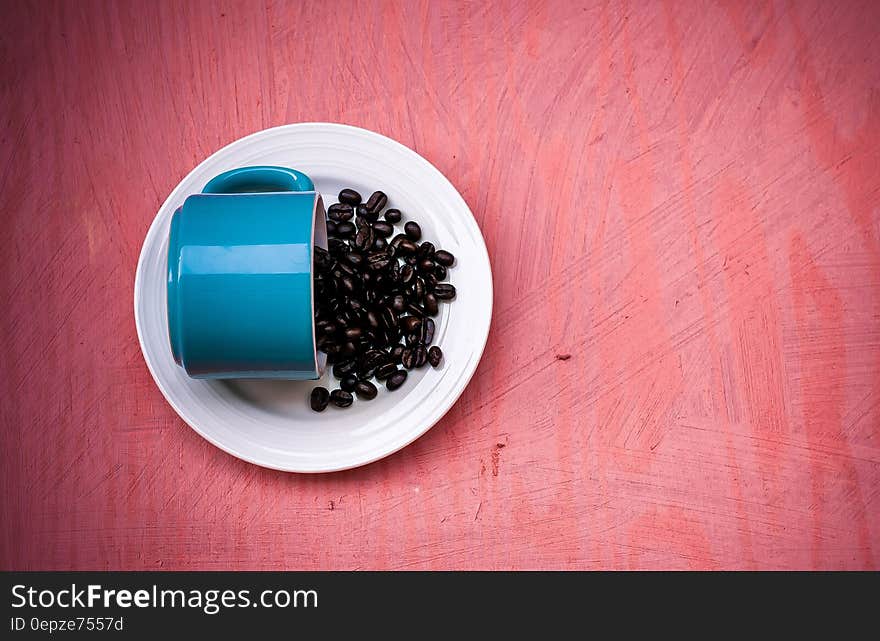 Blue Ceramic Tea Cup With Beans on Plate