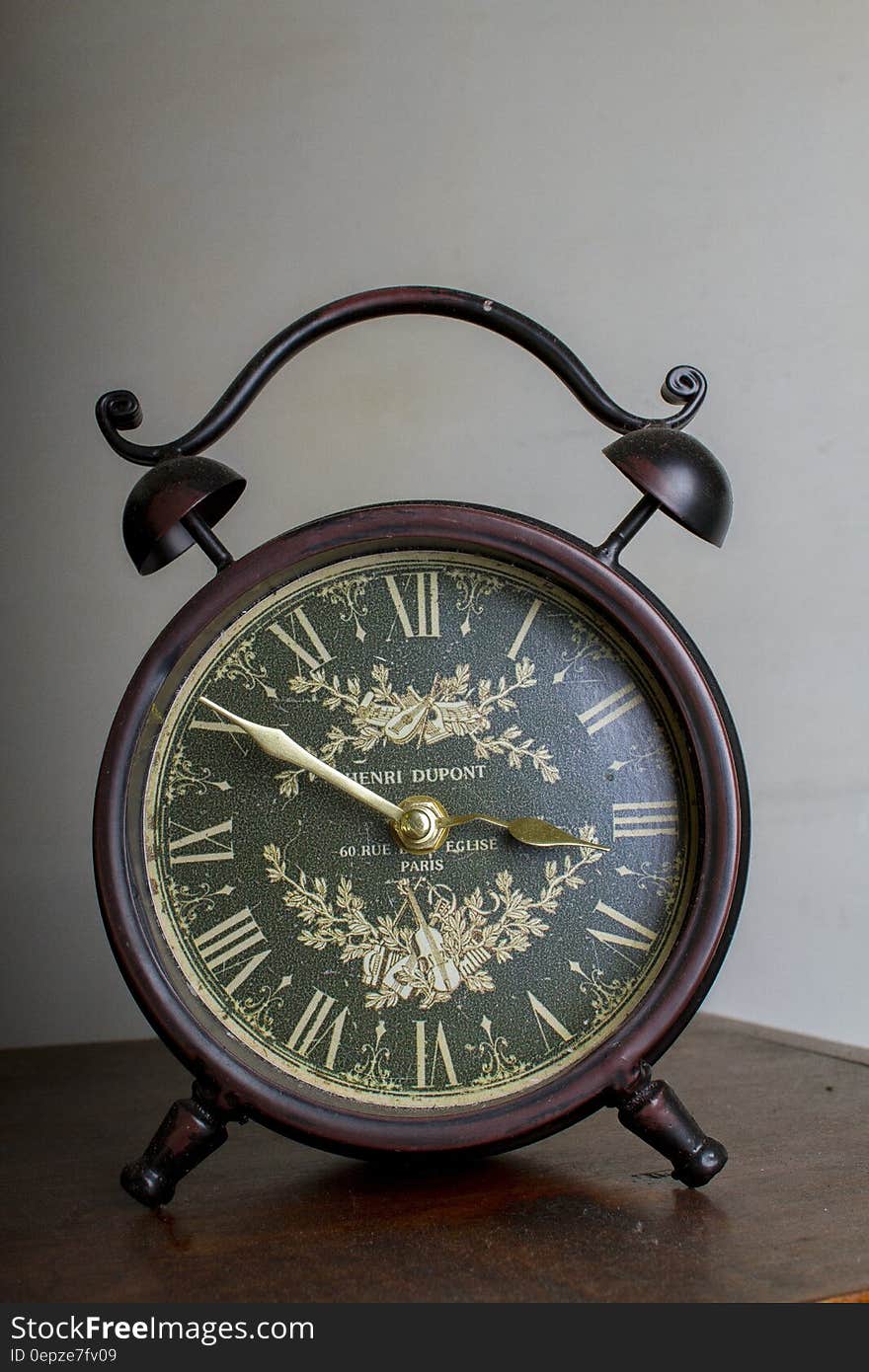 Brown Framed Alarm Clock on Brown Table