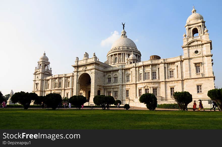 Palace exterior with green lawn on sunny day against blue skies. Palace exterior with green lawn on sunny day against blue skies.