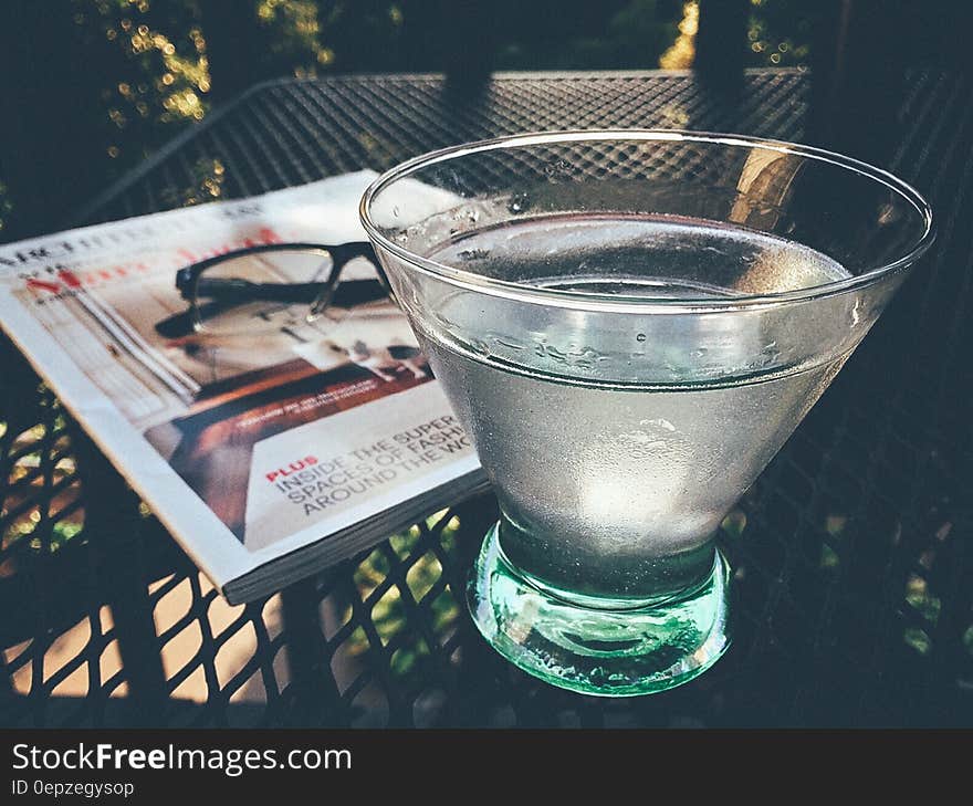 Glass Cup Filled With Water on Black Table