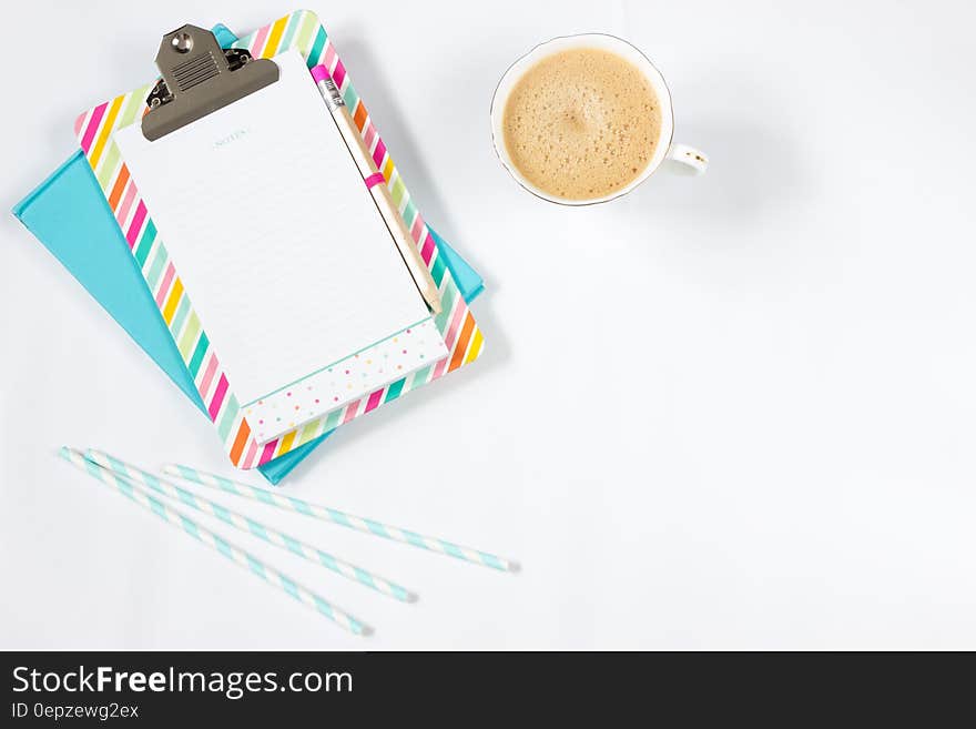 White Ceramic Teacup Beside Grey Paper Clip