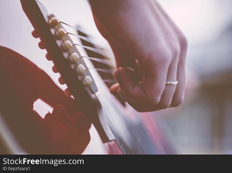 Person Playing Guitar