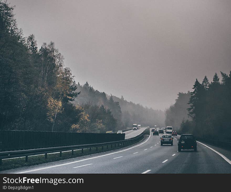 Cars and trucks on Autobahn in Germany on foggy day. Cars and trucks on Autobahn in Germany on foggy day.