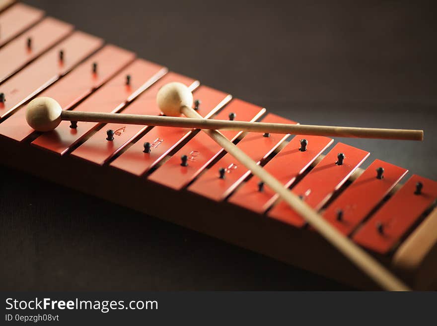 Shallow Focus Photography of Red Xylophone