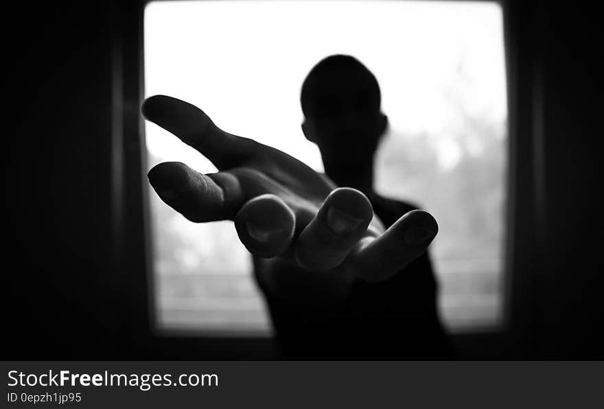 Man&#x27;s Hand in Shallow Focus and Grayscale Photography