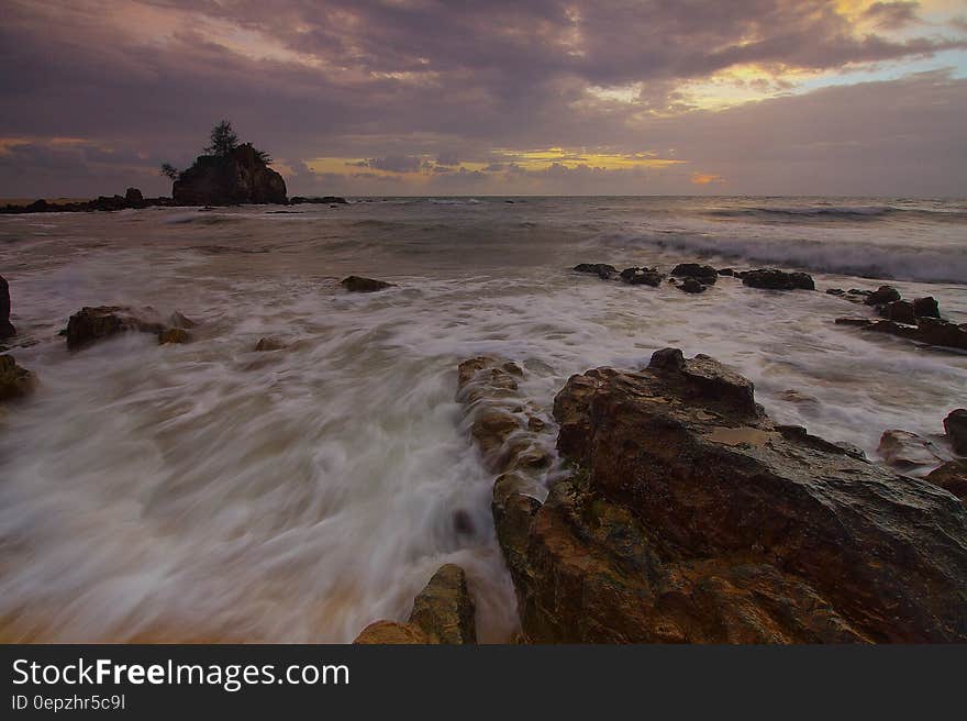 Flowing Water to the Ocean Under Grey Sky