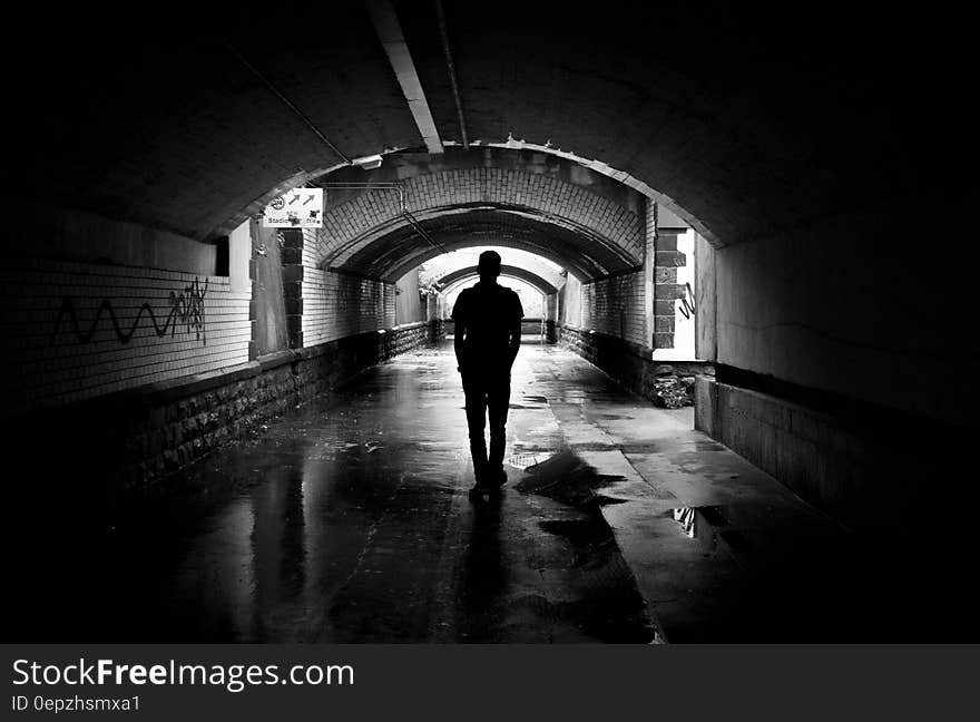 Silhouette Photo of a Man in a Tunnel