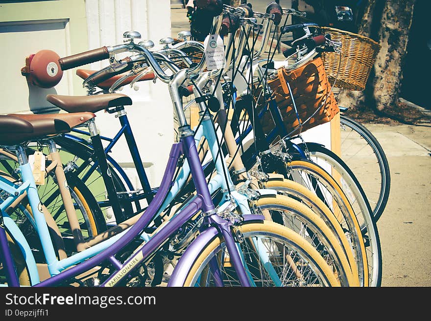 Row of bicycles on streets on sunny day.