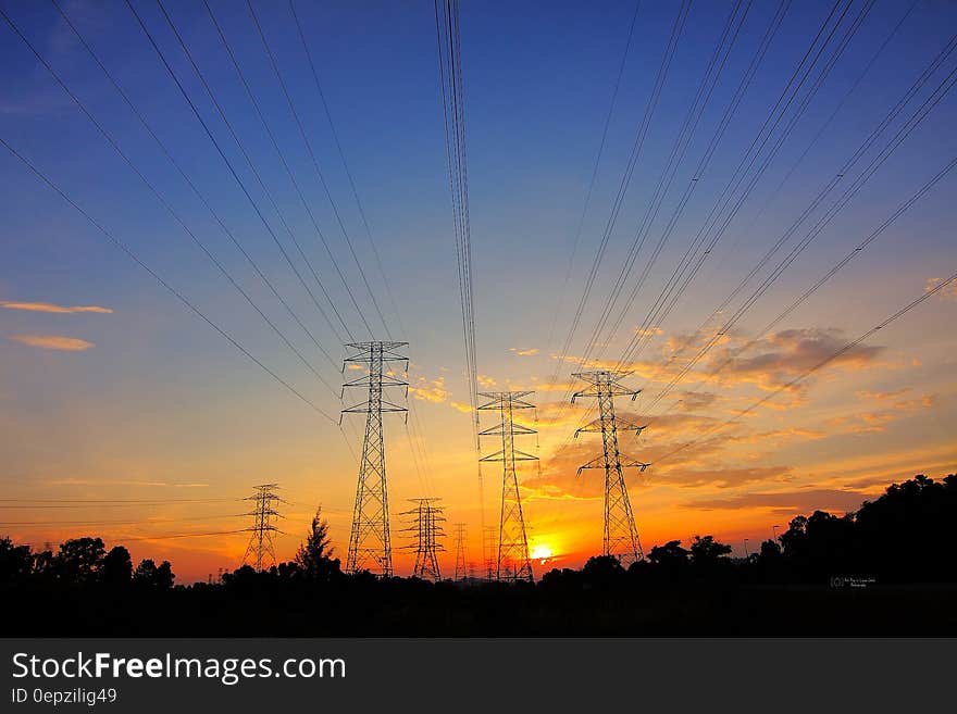 Power lines and transformers in rural countryside at sunset. Power lines and transformers in rural countryside at sunset.