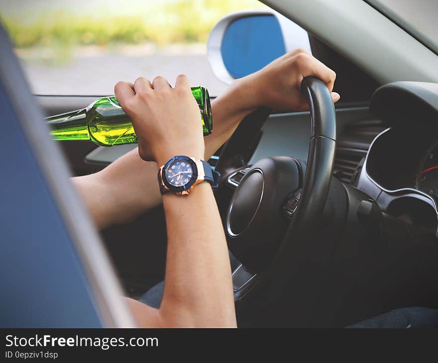 Person Driving and Drinking