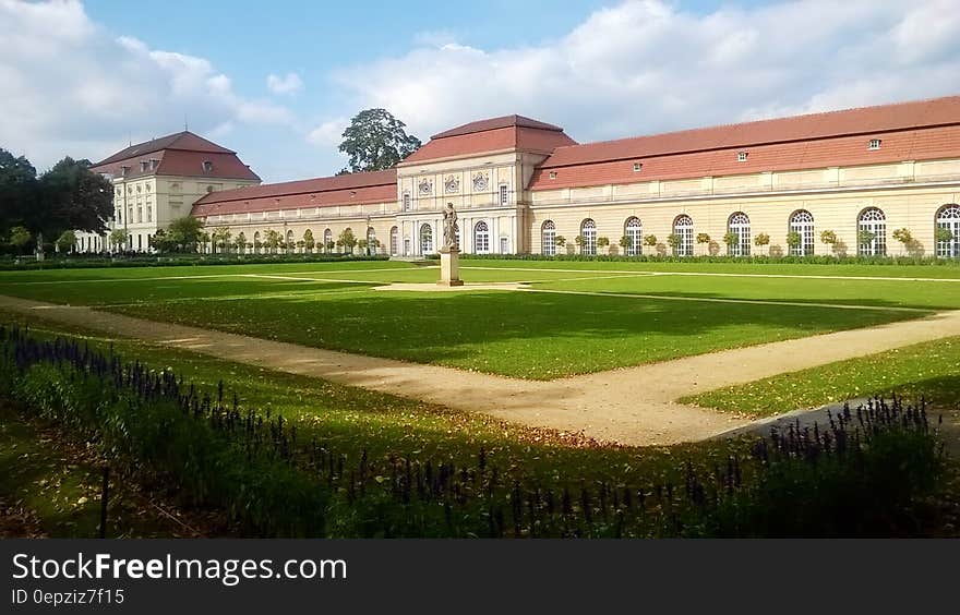 Exterior of Charlottenburg Castle, Berlin, Germany with green lawns on sunny day.