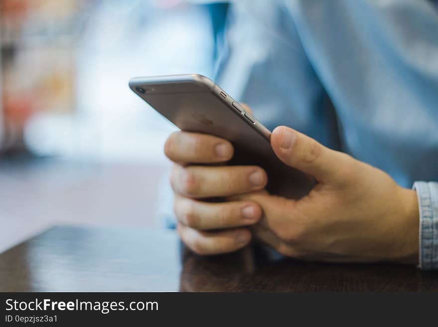 Close up of hand holding Apple iphone 6 smartphone. Close up of hand holding Apple iphone 6 smartphone.