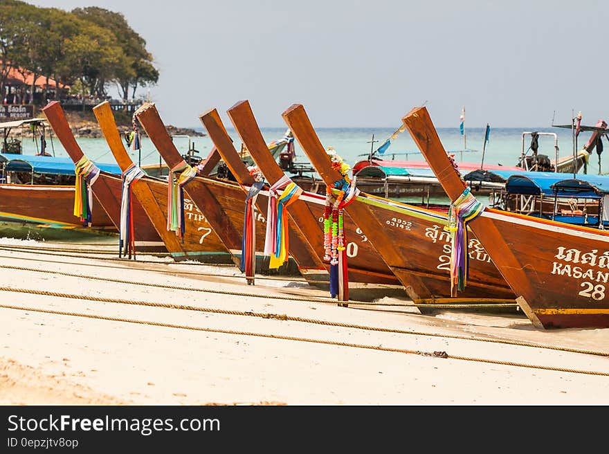 Brown Wooden Docked Boat at Daytime