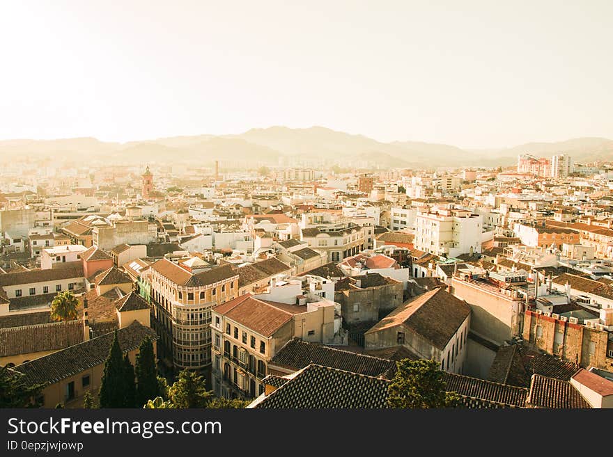 Aerial view over rooftops of Spanish city with haze.