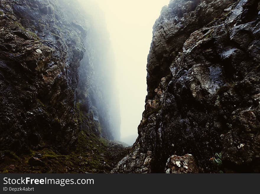 Misty gap between rocky cliffs in Scotland.