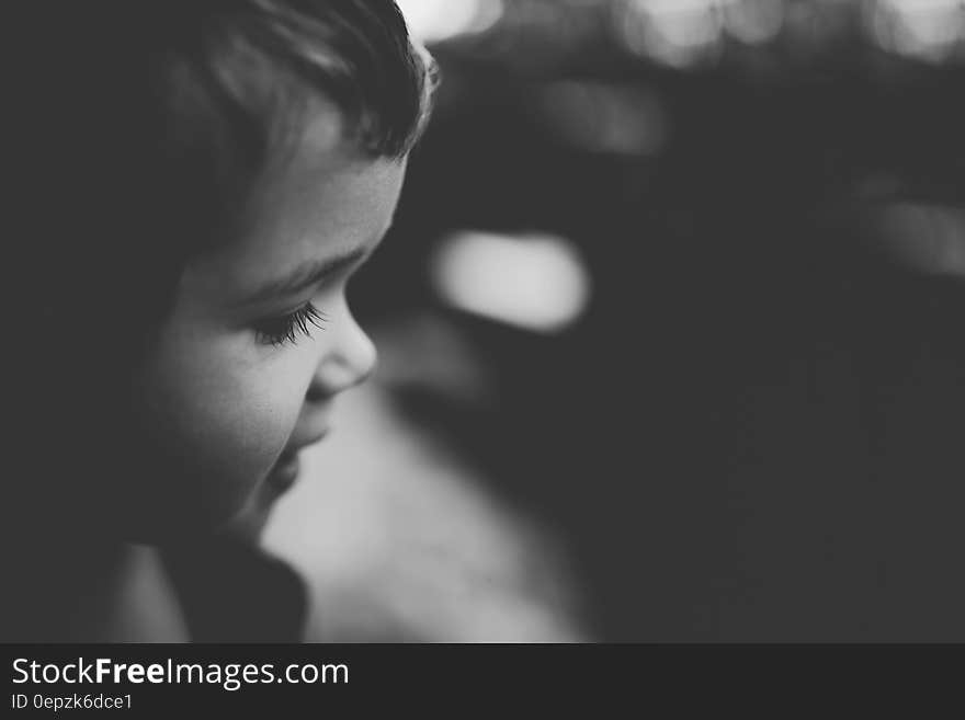 Profile portrait of child outdoors in black and white. Profile portrait of child outdoors in black and white.