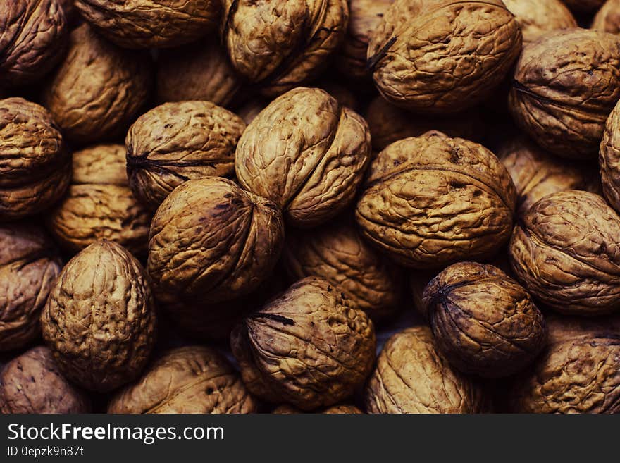 Close up of whole walnuts in the shell.