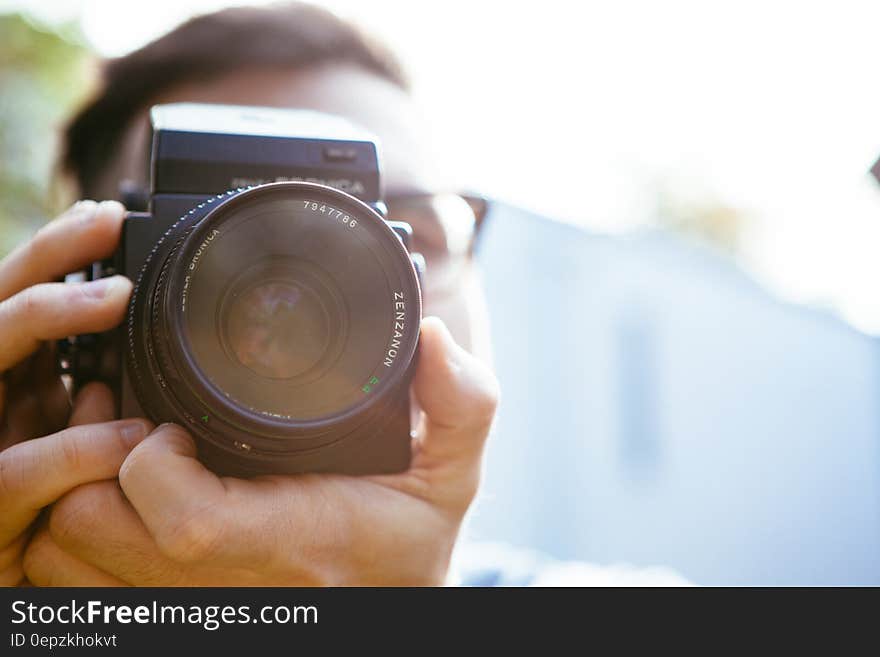 Portrait of boy taking picture with Bronica medium format camera. Portrait of boy taking picture with Bronica medium format camera.