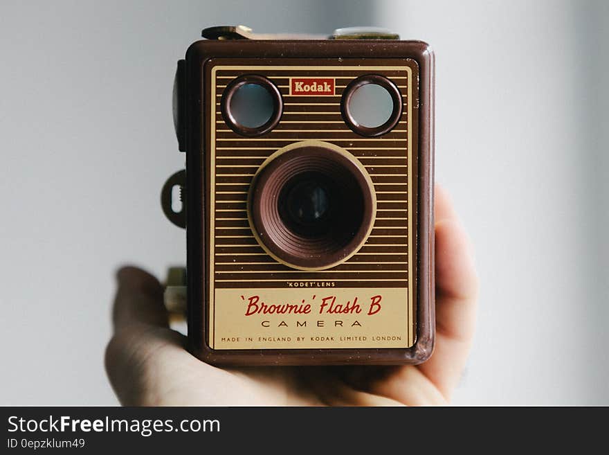 Hand holding vintage Kodak Brownie analog film camera. Hand holding vintage Kodak Brownie analog film camera.