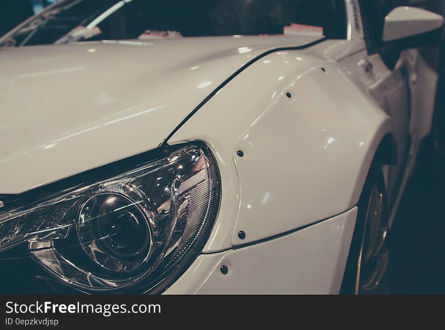 Close View of White Cars Left Headlight