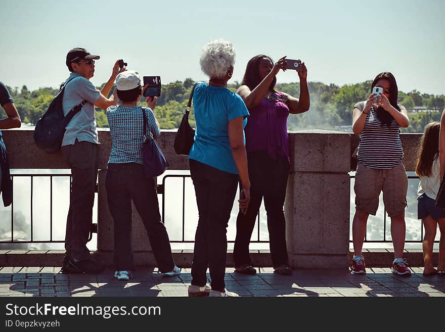 People Taking Pictures during Daytime