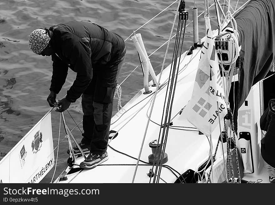 Man in Black Gray Jacket on a Boat&#x27;s Railing