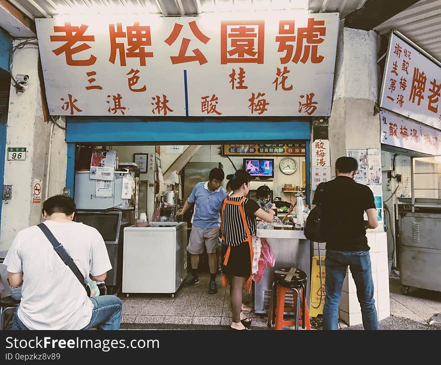 Person in Black Shirt Standing in Front of Store