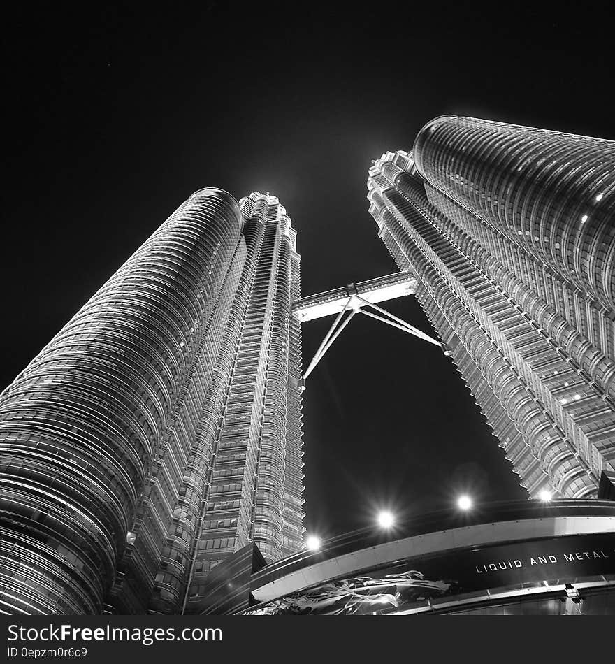 Facade of Petronas Twin Towers in Kuala Lumpur, Malaysia illuminated at night in black and white. Facade of Petronas Twin Towers in Kuala Lumpur, Malaysia illuminated at night in black and white.