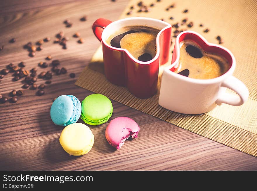 White and Red Couple Heart Mug Filled With Coffee And Macaroons