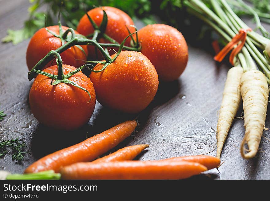 Tomatoes, Carrots And Radish On The Top Of The Table