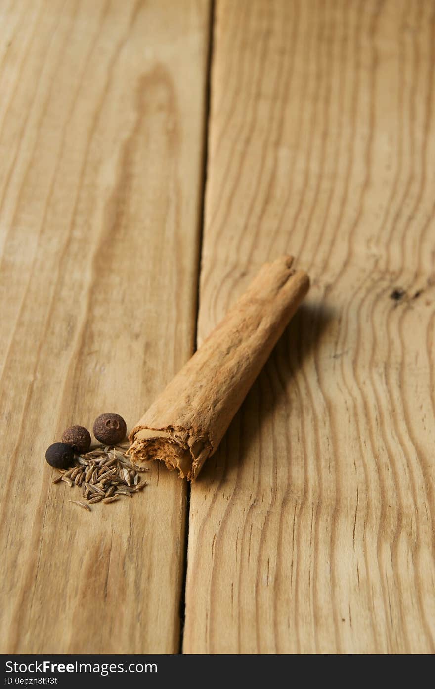 Cinnamon, peppers and seeds on a wooden background. Cinnamon, peppers and seeds on a wooden background.