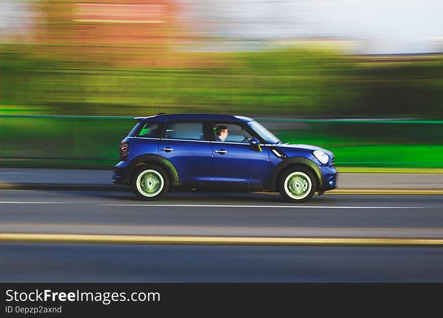 Blur of panning with blue car driving Autobahn in Germany on sunny day. Blur of panning with blue car driving Autobahn in Germany on sunny day.