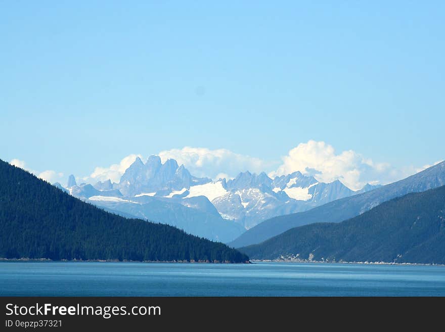 Mountain With Snow Cap Under Cloudy Sky at Daytime