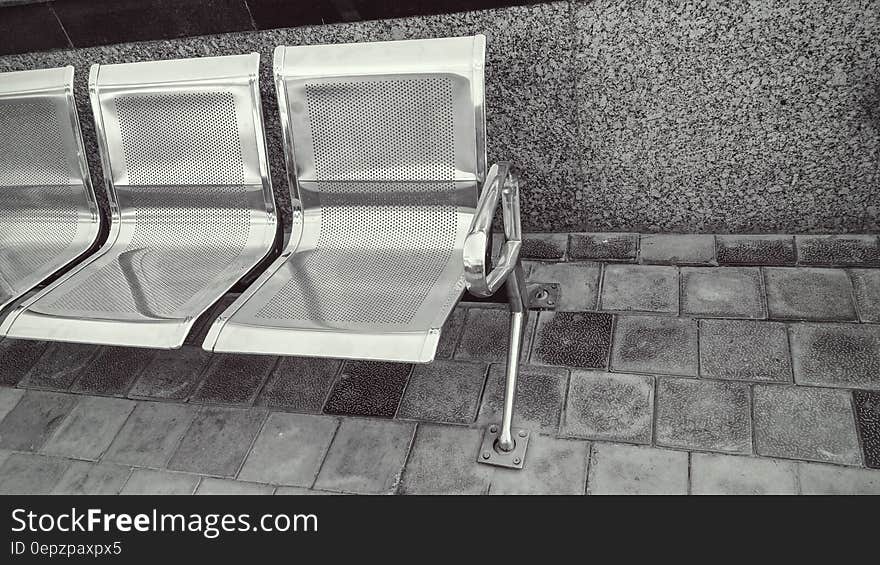 Stainless Steel Bench on Top of Gray Pavement