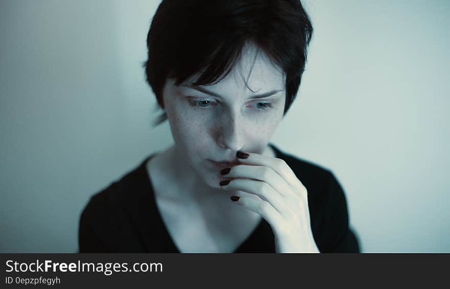 Woman Hands on Her Lips in Black Top