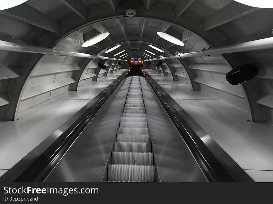 An escalator in a tunnel. An escalator in a tunnel.