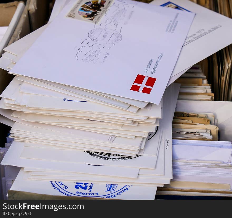 Stack of letters and postcards with stamps.