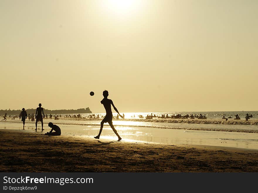 Silluhette of Man Playing Ball Near the Seashore