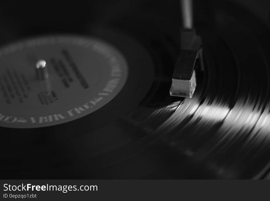 A vinyl record on a turntable music player. A vinyl record on a turntable music player.