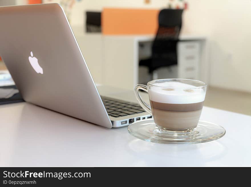 Macbook Pro Besides Clear Glass Mug