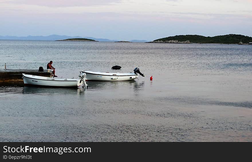 2 White Boat on Beach during Daytime