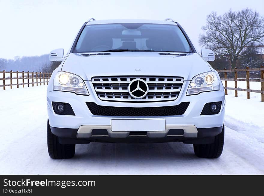 White Mercedes Benz Car on White Snow Covered Ground at Daytime